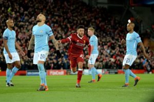 Players of ManCity react as Liverpool's Alex Oxlade-Chamberlain celebrates after scoring.