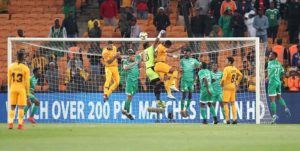Patrick Tignyemb of Bloemfontein Celtic clears ball from Siyabonga Ngezana of Kaizer Chiefs.