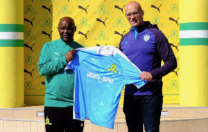 Mamelodi Sundowns coach Pitso Mosimane hands the new kit to Bulls coach John Mitchell