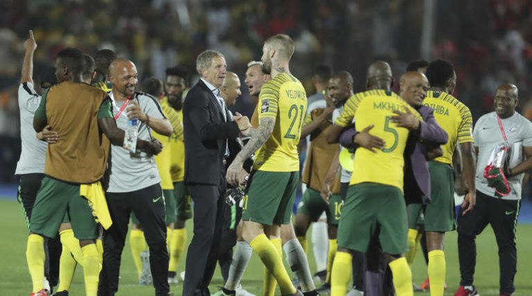 Bafana Bafana head coach Stuart Baxter celebrates with his player after beating Egypt
