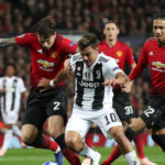 Manchester United's Victor Lindelof and Juventus' Paulo Dybala battle for the ball during the UEFA Champions League match at Old Trafford, Manchester.