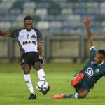 Lehlohonolo Majoro of Amazulu try's to defend an attack from Arsene Zola Kiaku of TP Mazembe FC