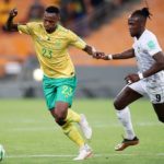 Thibang Phete of South Africa challenged by David Moyo of Zimbabwe during the 2022 World Cup Qualifier Bafana