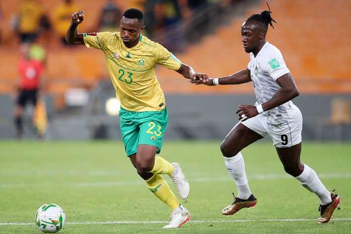 Thibang Phete of South Africa challenged by David Moyo of Zimbabwe during the 2022 World Cup Qualifier Bafana