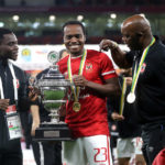 Percy Tau of Al Ahly celebrates with the CAF Super Cup trophy as Al Ahly coach Pitso Mosimane looks on during the 2021 CAF Super Cup match between Al Ahly and Raja Casablanca held at the Ahmed bin Ali Stadium in Al Rayyan, Qatar on 22 December 2021 ©Mohamed Bissar/BackpagePix