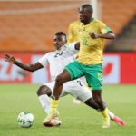 Bongokuhle Hlongwane of South Africa tackled by Farai Madhanaga of Zimbabwe during the 2022 World Cup Qualifier match between South Africa and Zimbabwe