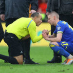 Oleksandr Zinchenko of Ukraine is consoled by referee Antonio Miguel Mateu Lahoz after their sides defeat during the FIFA World Cup Qualifier between Wales and Ukraine at Cardiff City Stadium on June 05, 2022 in Cardiff, Wales. (Photo by Michael Steele/Getty Images)