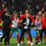Morocco's coach Walid Regragui (C) and his players greet the fans after the friendly football match between Morocco and Brazil at the Ibn Batouta Stadium in Tangier on March 26, 2023. (Photo by Fadel Senna / AFP)